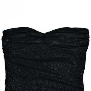 Detail of black sequin fabric with shimmering starlight effect and ruched chest design