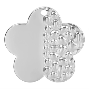 Close-up of silver flower pendant with hammer texture and polished finish on white background