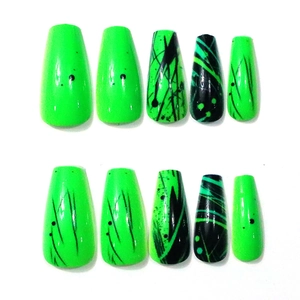 Detail of neon green trapezoid press-on nails with black abstract stripe patterns