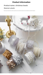 Detail of Christmas beaded garland rolls with star and snowflake shapes on white table