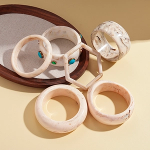 Minimalist resin bangle set with marble patterns and geometric hexagonal shapes