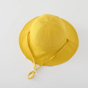 Close-up of yellow cotton sun hat for kids with adjustable windproof cord and stitched brim
