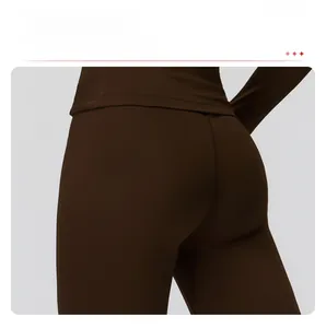 Detail view of high-waist yoga leggings showing elastic fabric and back peach-line seam