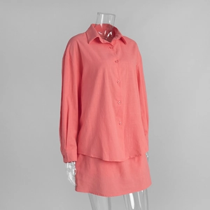Close-up of coral pink cotton long-sleeve shirt and matching mini skirt set