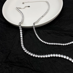 Detail of S925 sterling silver tennis necklace with 5A zircons on black and white surface