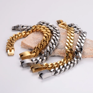 Mens heavy Cuban link bracelets in 18K gold and silver stainless steel on stone