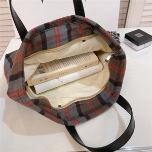 Macro view of interior lining and zipper closure on vintage plaid tote handbag