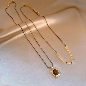 Gold plated tiger eye stone square necklace featuring a vintage layered chain design
