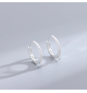 Detail of S925 sterling silver hoop earrings with cubic zirconia and a bottom small ring