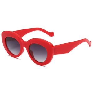 Retro Y2K oval chunky red sunglasses with dark grey gradient lenses on white background