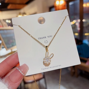 Macro shot of gold-toned bunny pendant with pavé cubic zirconia on a delicate cable chain