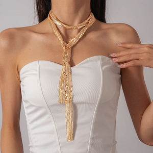 Detailed view of luxury gold fringe necklace with shimmering rhinestones on a model