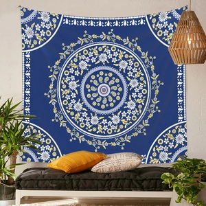Detail of blue mandala tapestry hung on brick wall in bohemian styled room setting