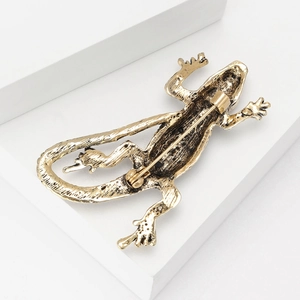Detailed back view of a vintage gold lizard brooch showing the pin clasp mechanism