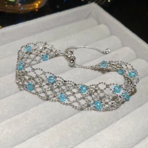 Detail of silver mesh bracelet with sky blue crystal beads and adjustable slide clasp