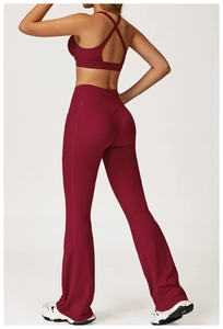 Back view of burgundy yoga set featuring criss-cross sports bra and high waisted flared pants