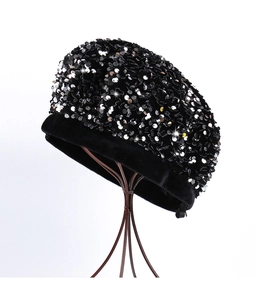 Detail of shimmering silver and gold sequins on a black velvet vintage beret hat