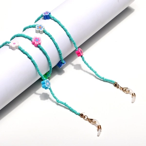 Detail of blue beaded chain with colorful flower charms and gold lobster clasps