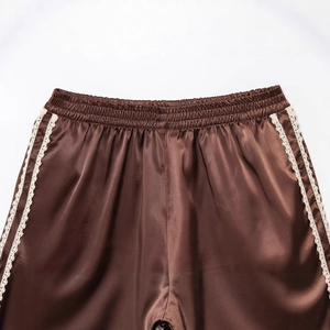 Brown satin casual shorts with elastic waist and delicate white lace trim on the sides