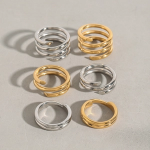 Detail of stacked spiral stainless steel rings in gold and silver finishes