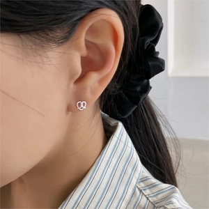Minimalist 925 sterling silver twisted heart stud earring worn on model for daily style