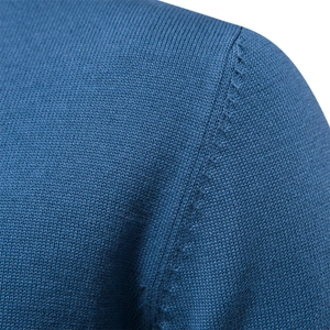 Close-up of shoulder seam craftsmanship and dense navy blue knit texture on sweater