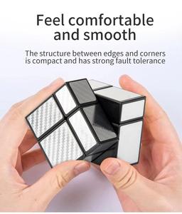 Macro shot of silver carbon fiber mirror cube being handled to show smooth rotation