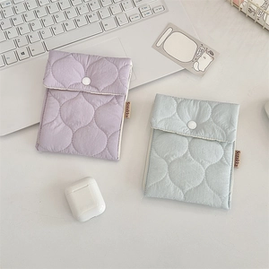 Detailed view of quilted lavender and mint green mini storage pouches for lipsticks.
