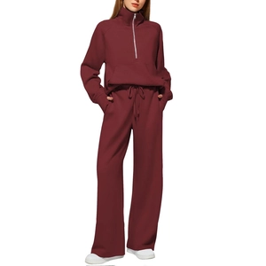 Women's burgundy two-piece loungewear set with half-zip sweatshirt and wide-leg sweatpants