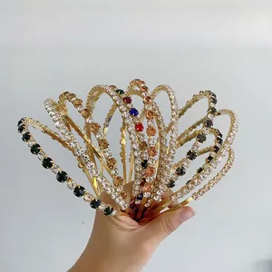 Macro view of multi-color rhinestones and pearls on hollow golden metal hairbands