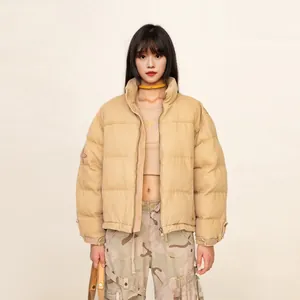 Front view of khaki cropped puffer jacket with stand collar and quilted design