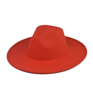 Top down view of a vibrant red wide brim wool fedora hat with a classic flat crown