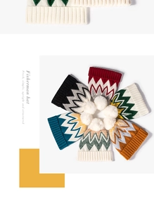 Top view of striped knit hats with white pom-poms in six vibrant color variations
