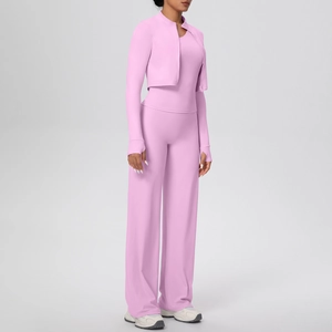 Close-up of pink three-piece yoga set featuring full-zip jacket and high-waisted wide-leg pants