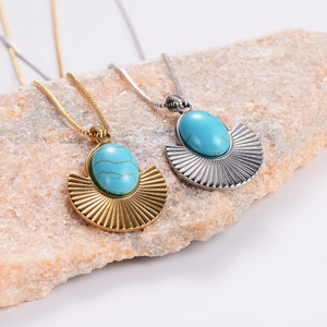 Detail of fan-shaped turquoise pendants on gold and silver stainless steel chains