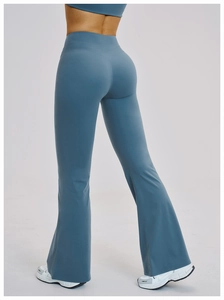 Detail view of high-waist flare yoga pants with V-shaped butt-lifting seam design in blue