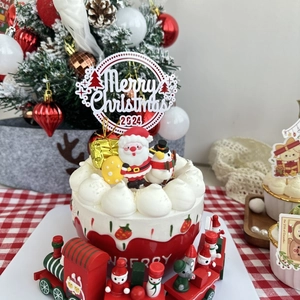 Macro shot of Merry Christmas 2024 acrylic cake topper with Santa and snowman figurines