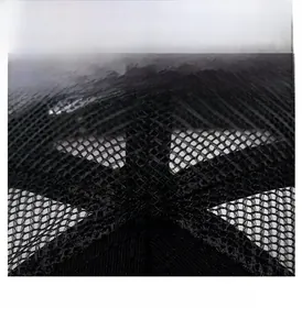 Detailed top view of a black mesh baseball cap showing button and sewing craft