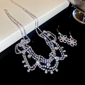 Close-up of luxury silver floral necklace and earring set with shimmering rhinestones