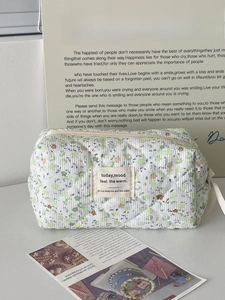 Quilted corduroy floral makeup bag in green and white with a vintage aesthetic