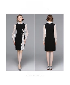 Dettaglio del ricamo floreale e delle maniche a sbuffo su un abito qipao nero moderno