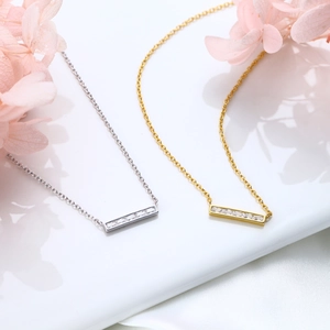 Macro shot of 925 silver and gold rectangle bar pendants with inlaid cubic zirconia