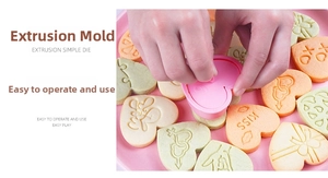 Detail of pink heart-shaped cookie mold with embossed LOVE patterns and DIY biscuits