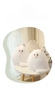 Close-up of two white Persian cat plush toys with fluffy fur and cute yellow eyes