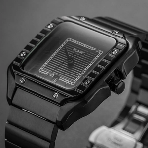 Macro shot of black square watch dial with horizontal texture and stainless steel metal case