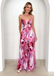 Close-up of pink floral jumpsuit featuring a front bow tie and cutout detail