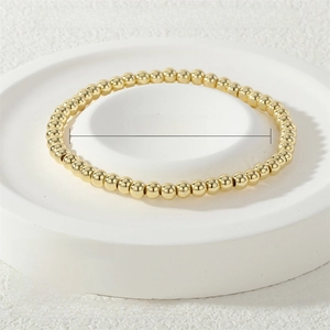 Detail of 4mm gold stretch metal bead bracelet showing 16-17cm circumference size specs