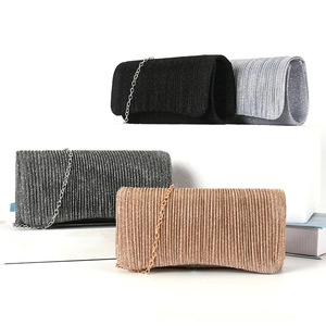 Detailed pleated texture of elegant evening clutch bags in multiple colors with metal chains