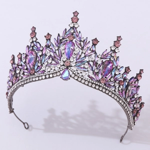 Close-up of luxury Baroque crown featuring purple and white rhinestones on metal base
