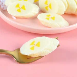 Creative banana slice shaped wax melt with radiation symbol on a gold fork